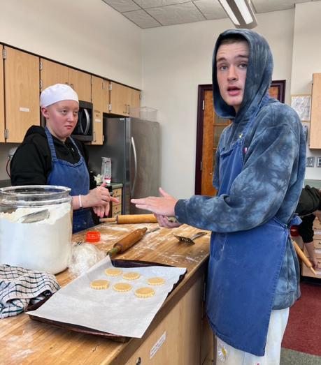 Teacher and student making cookies