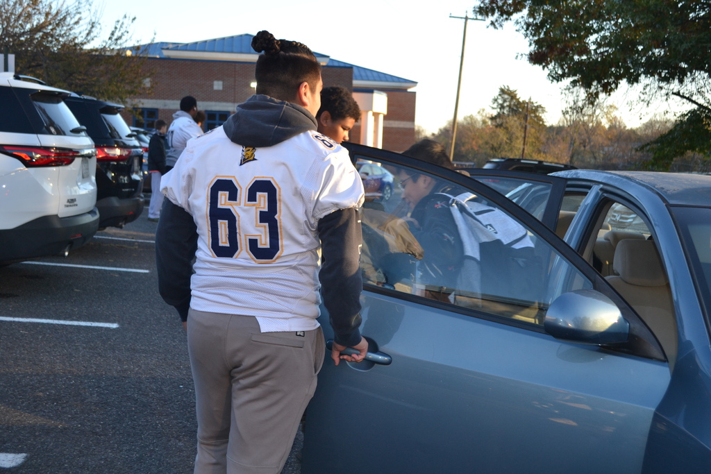 CCHS football team helps open doors during car drop off