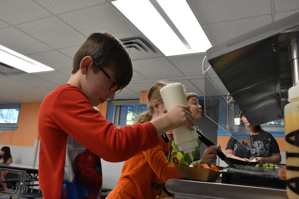 Elementary school students are pictured using the school’s new salad bar during lunch earlier this month.