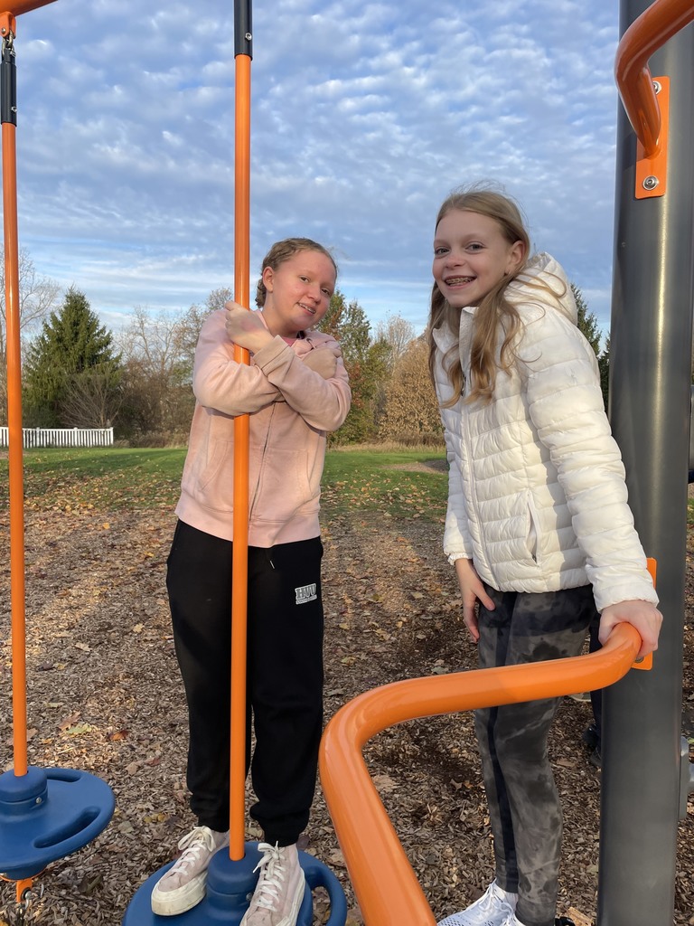 girls on play structure smiling