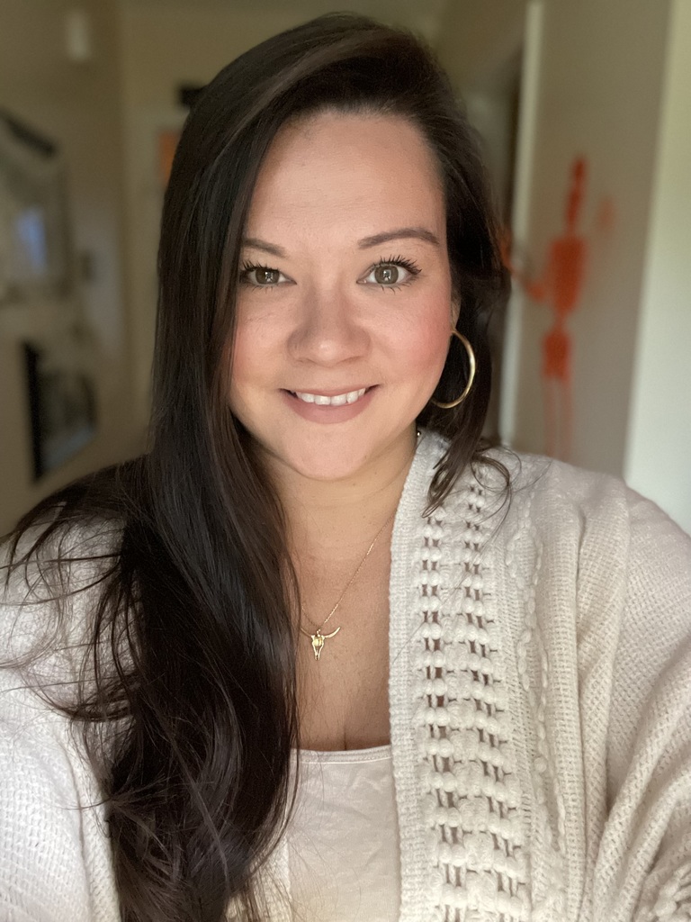 A woman smiles at the camera.