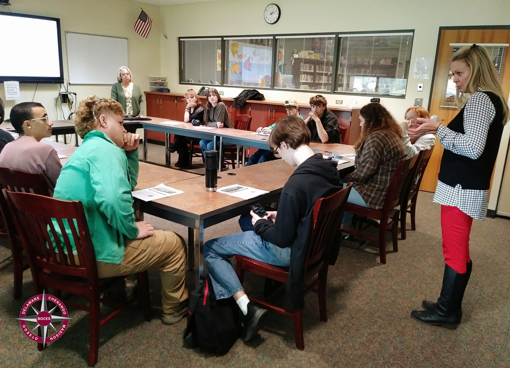 Adult career counselor speaking to students in a classroom