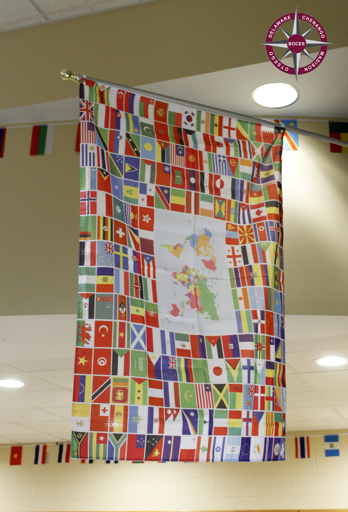 photo of flag that is made up up many little flags from around the world