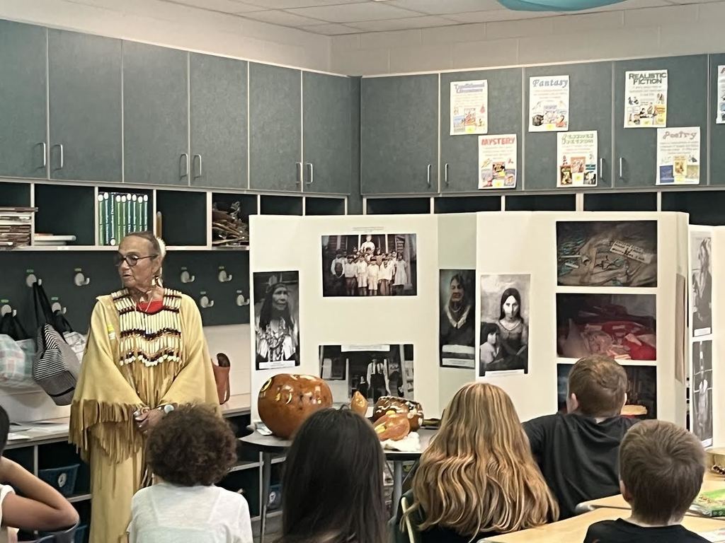 A native woman talks to students about her culture.