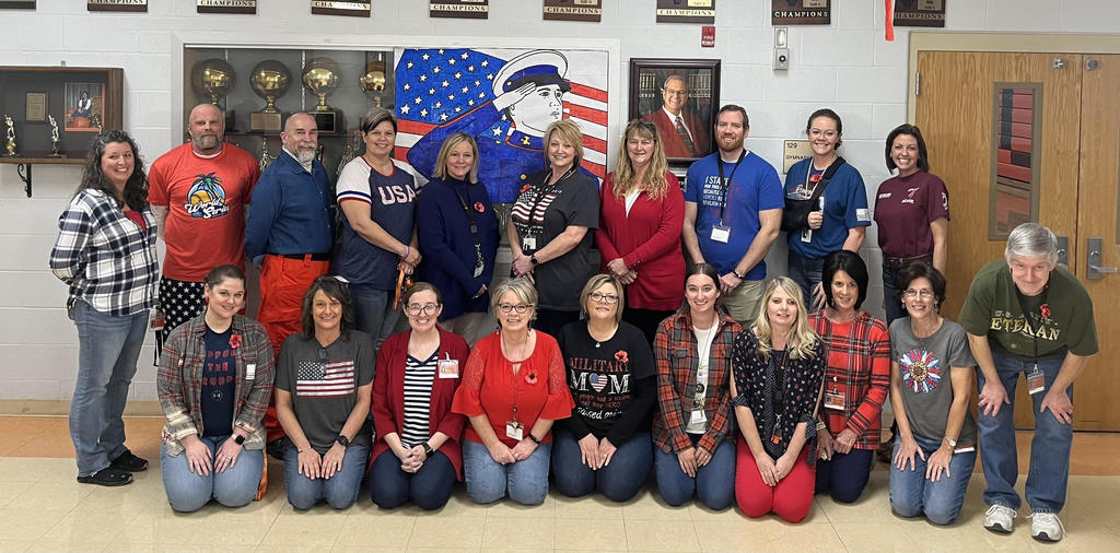 Teachers dressed in patriotic colors standing in a hallway