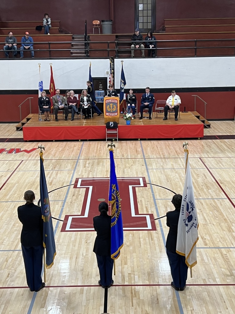 Students hold flags for a ceremony