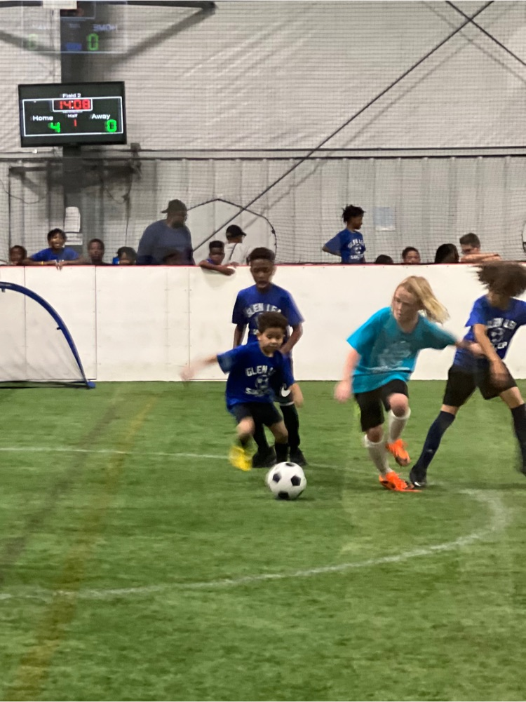 2nd grade student dribbles down the field