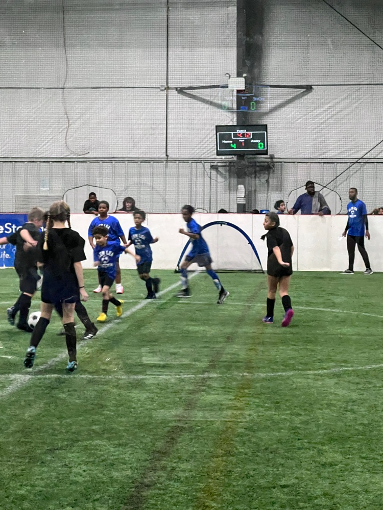 Students prepare to kick the ball down the field