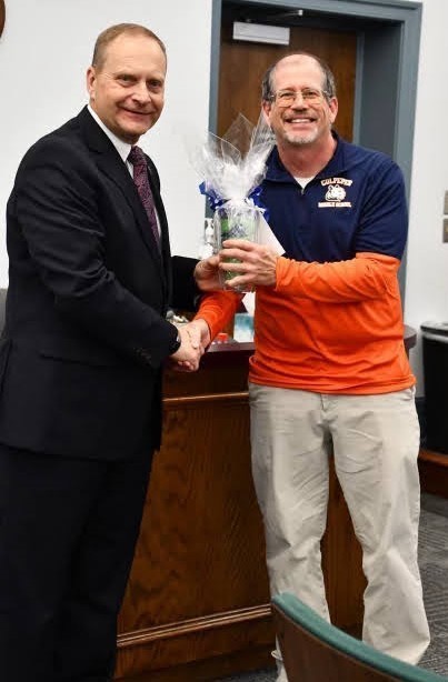 Mr. Mitchell shaking hands with Dr. Brads