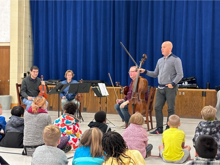 Orchestra member shows his instrument