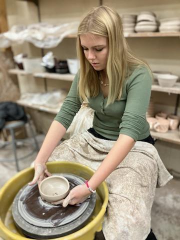 Girl at potters wheel