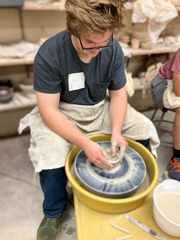 boy making pottery