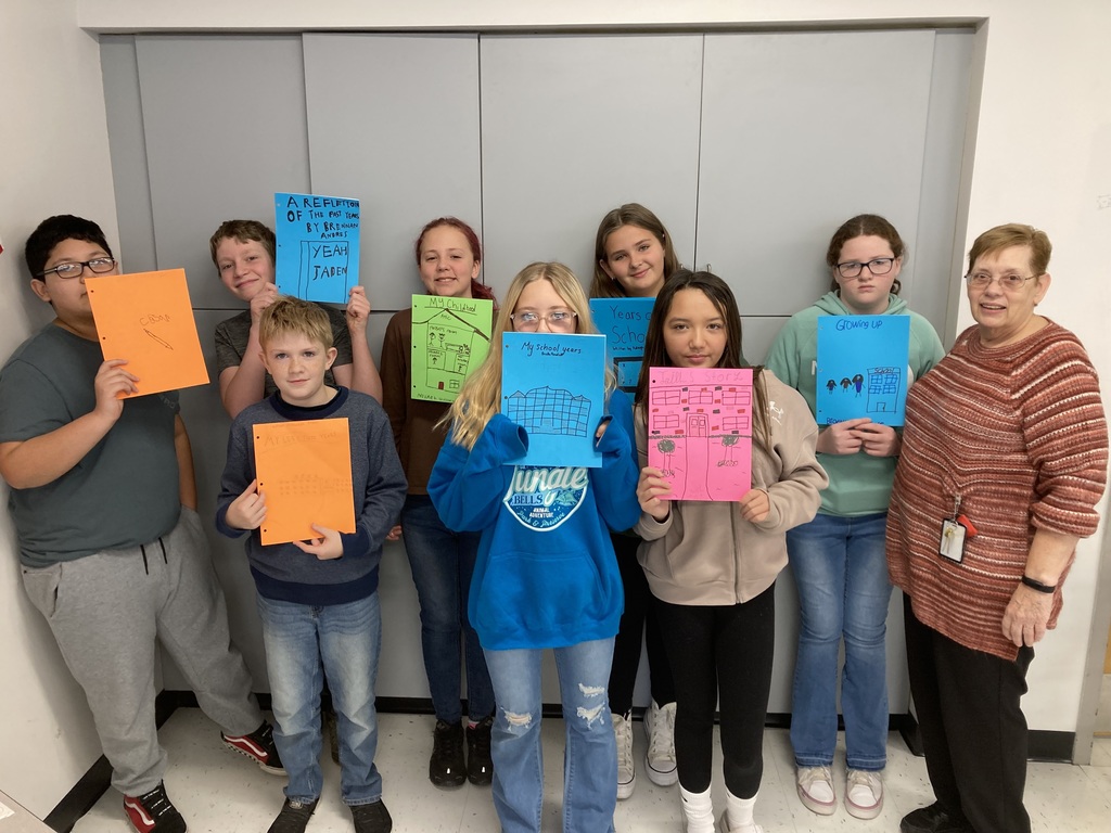 Ms. Covey's 6th-grade students with their books. 