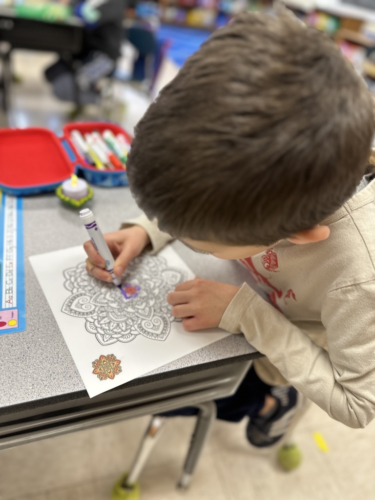 student coloring rangoli