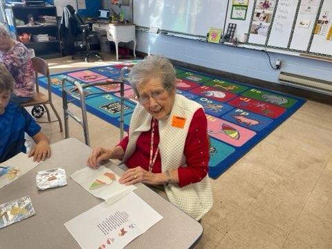 elderly woman working on art project