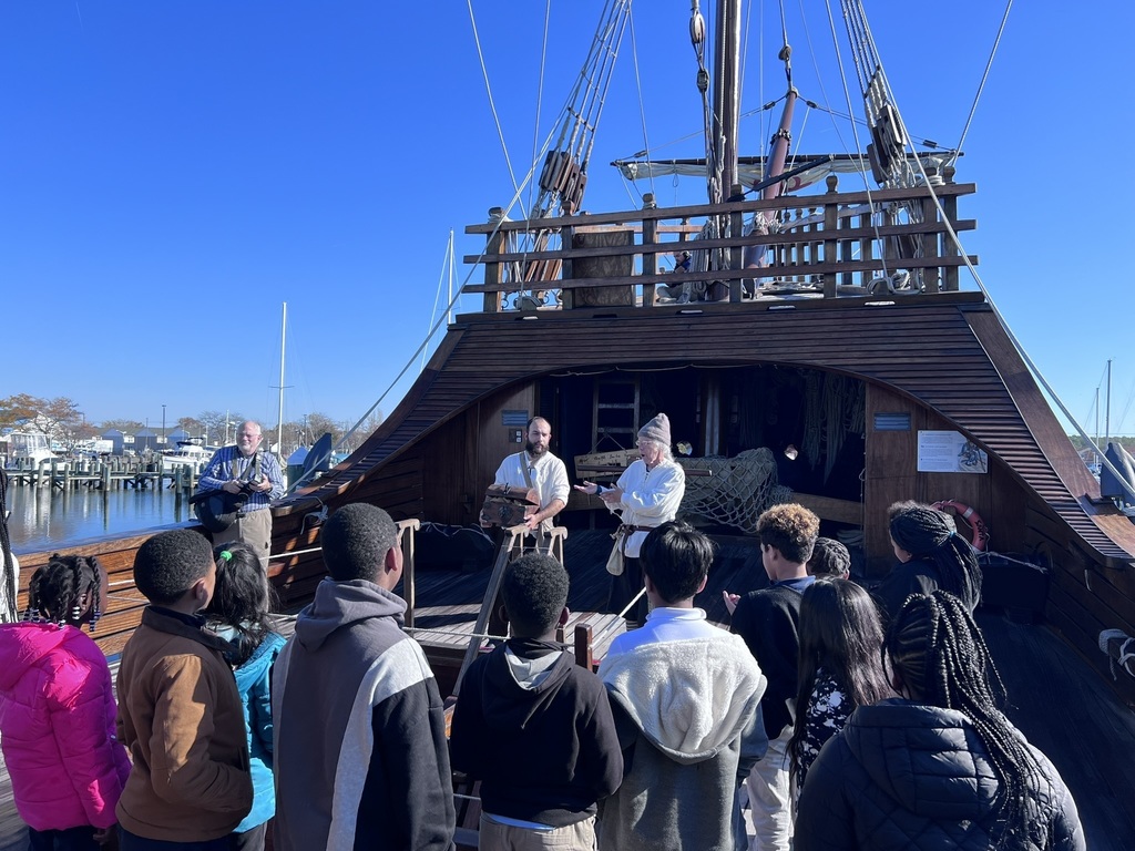 students listening to the ship's crew talk about life on the ship