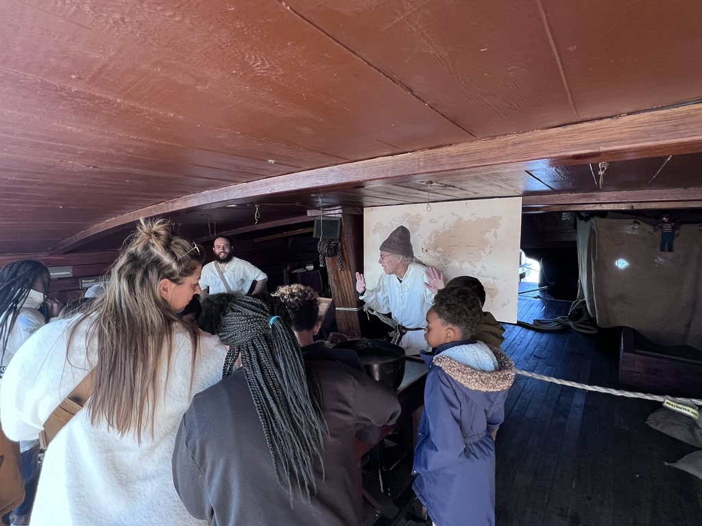 students gathered to listen to a presentation on the ship