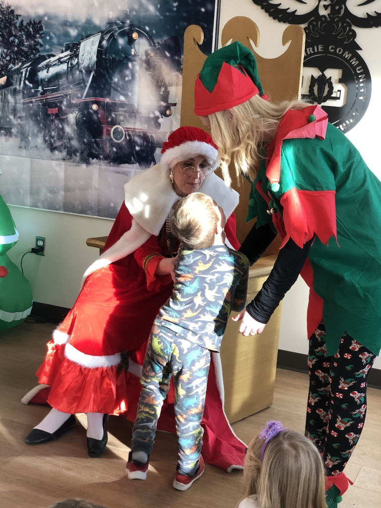 Mrs Claus and and Jingles the Elf listen to Christmas wishes.