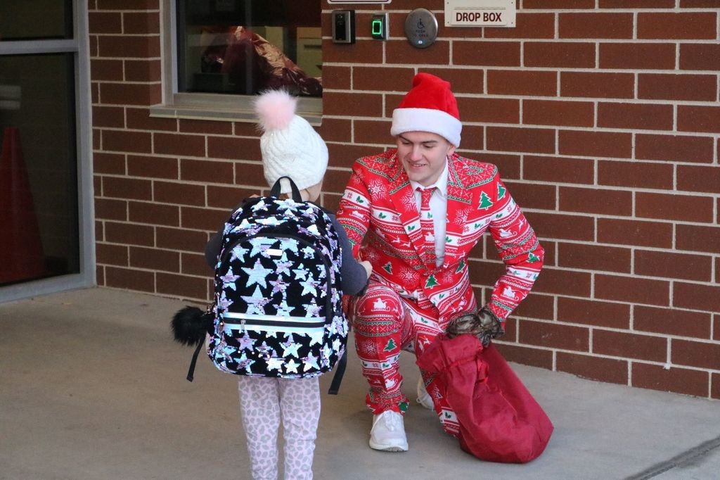 Jason Oyen hands out candy canes to Potosi students