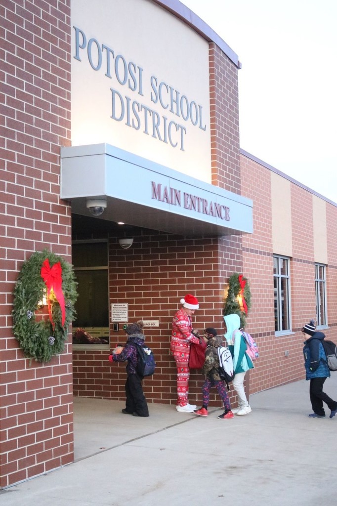 Jason Oyen hands out candy canes to Potosi students