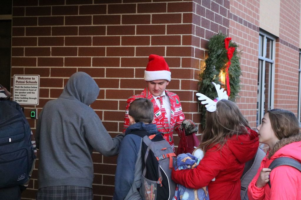 Jason Oyen hands out candy canes to Potosi students
