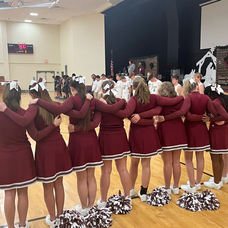 GCS cheerleaders praying before a game