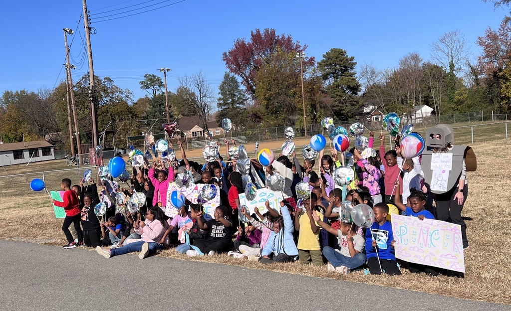 All of the 2nd graders pose with their balloons.