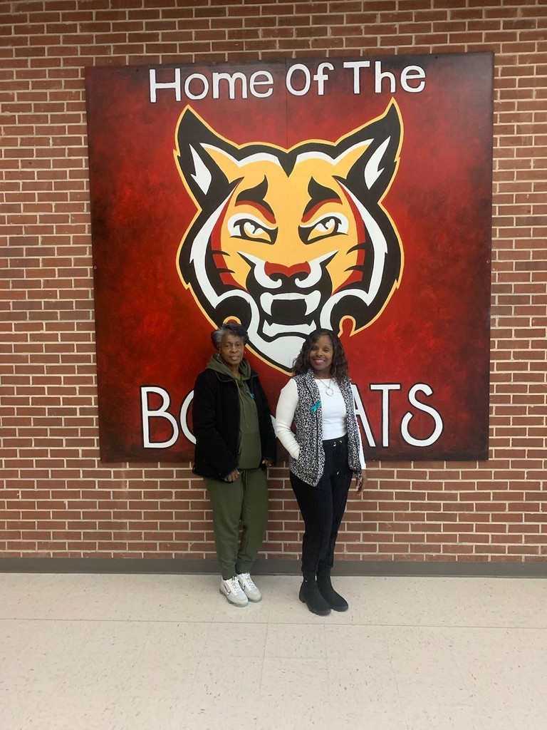 2 ladies in front of Bobcat mural