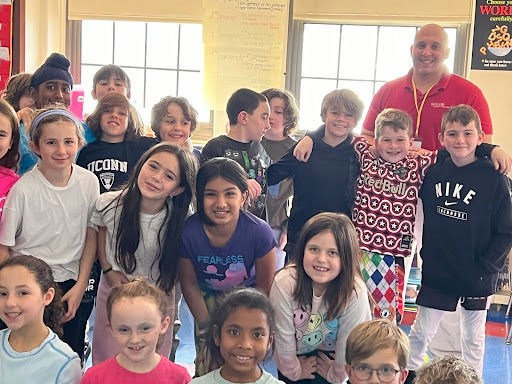 fourth grade students posing with Chris from Rutgers