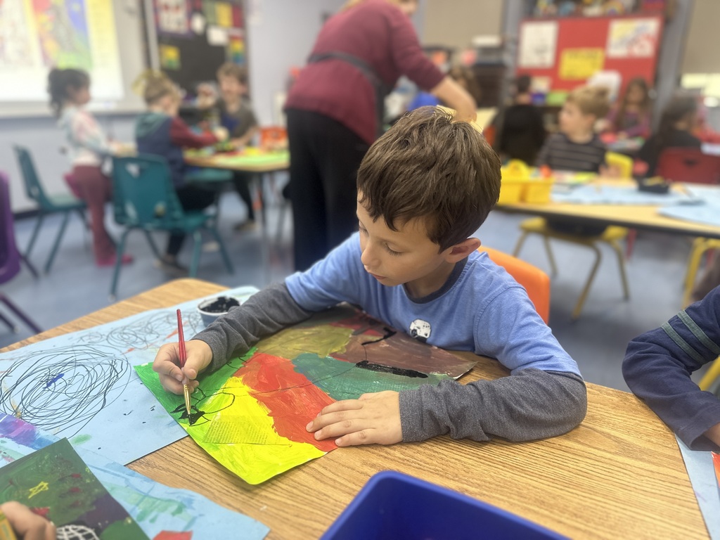 first grade student working on their painting