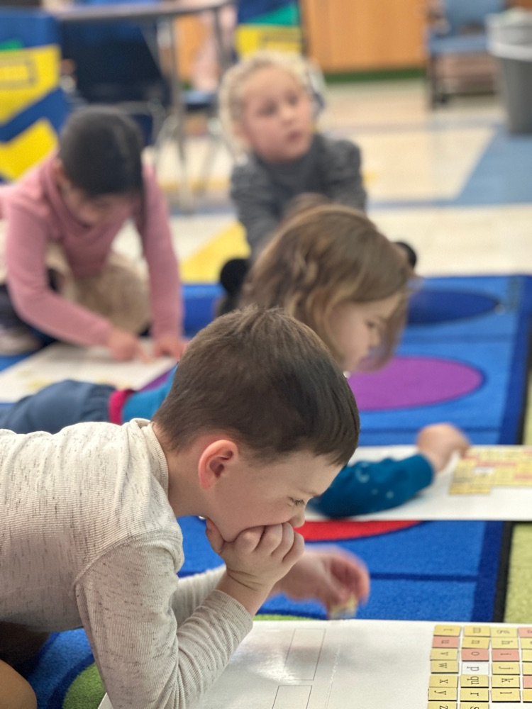 students manipulate letter tiles