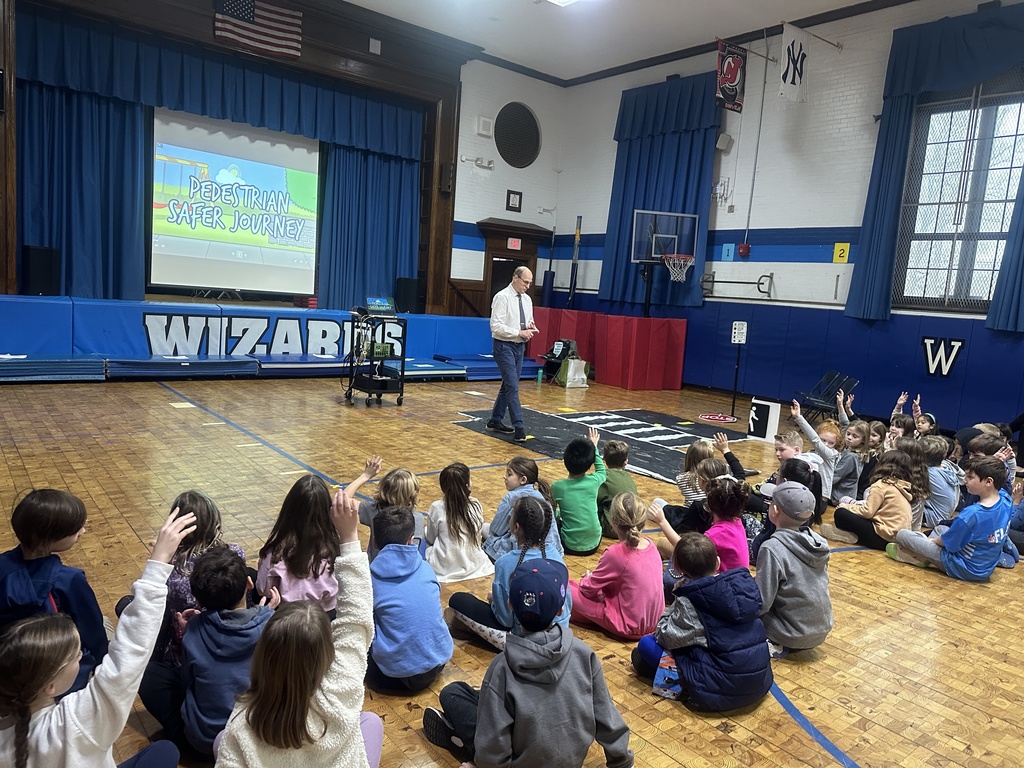 second grade students listening to pedestrian safety presentation