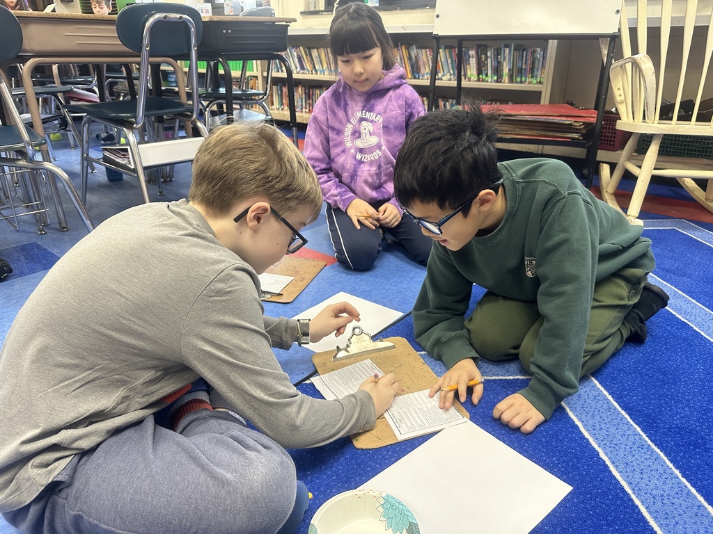 three fourth grade students playing decimal yahtzee