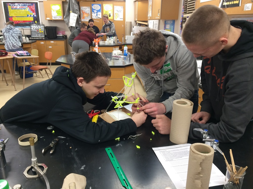 8th graders building straw towers