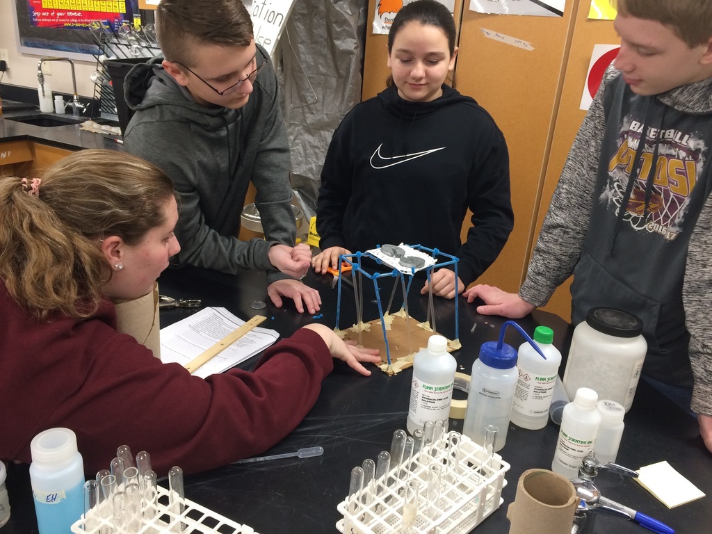 8th graders building straw towers