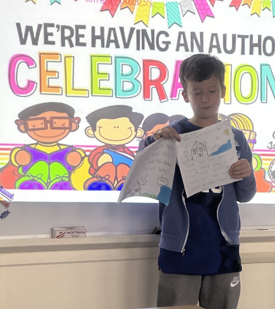 student reading their finished writing piece