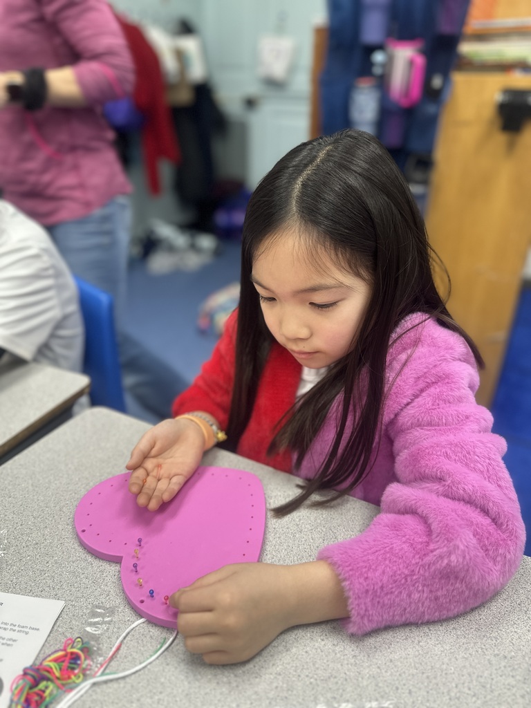 student making a heart craft on Valentine's Day