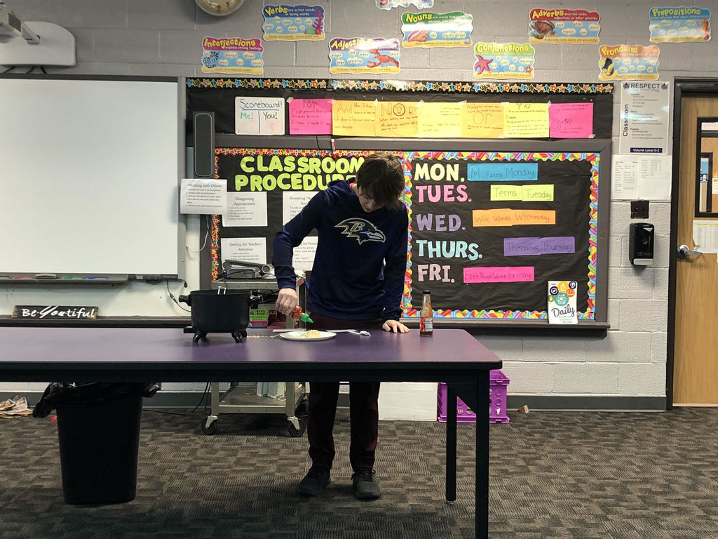 Cael demonstrating how to make spicy noodles