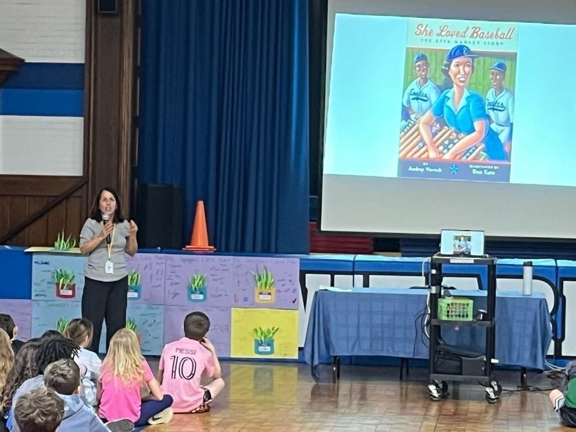Author talking to students about the book She Loved Baseball