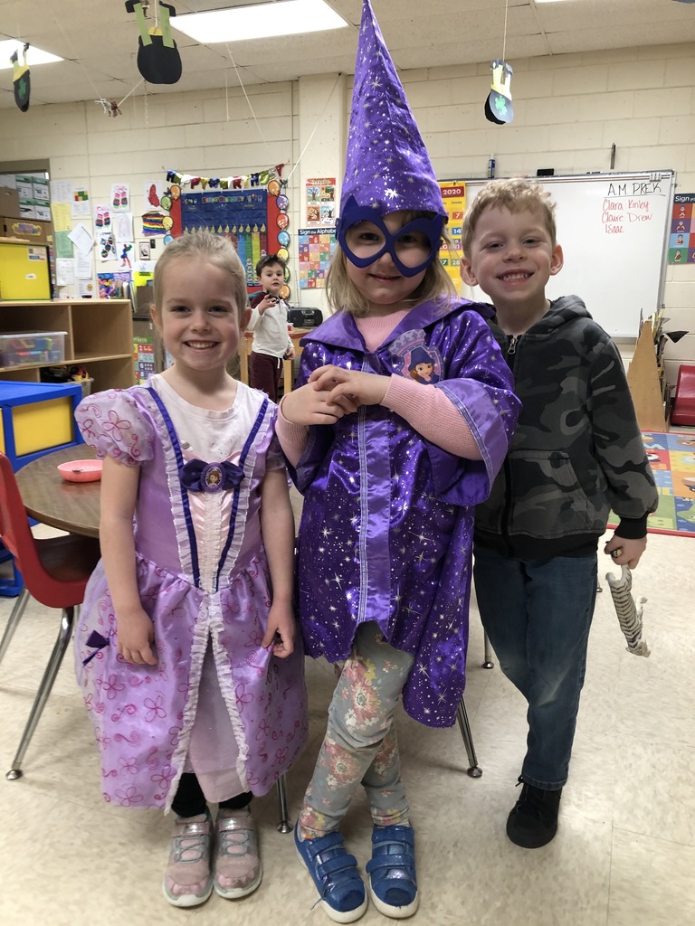 Three kids in dress up clothes. 