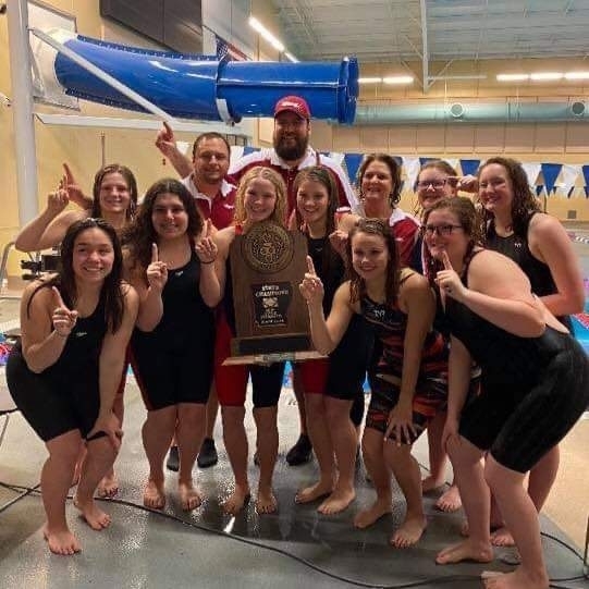 Swimmers posing with trophy