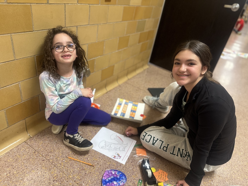 two students sitting together in the hallway