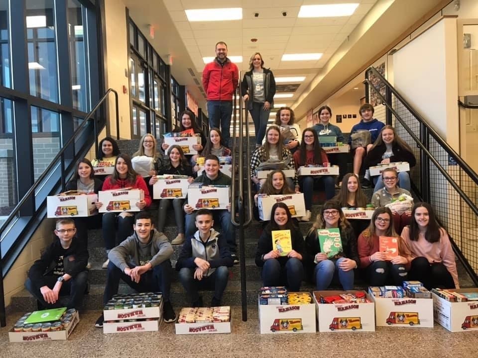 National Junior Honor Society students with the items they brought in to benefit Everett Elementary's weekend backpack program. There were over 500 donated items!