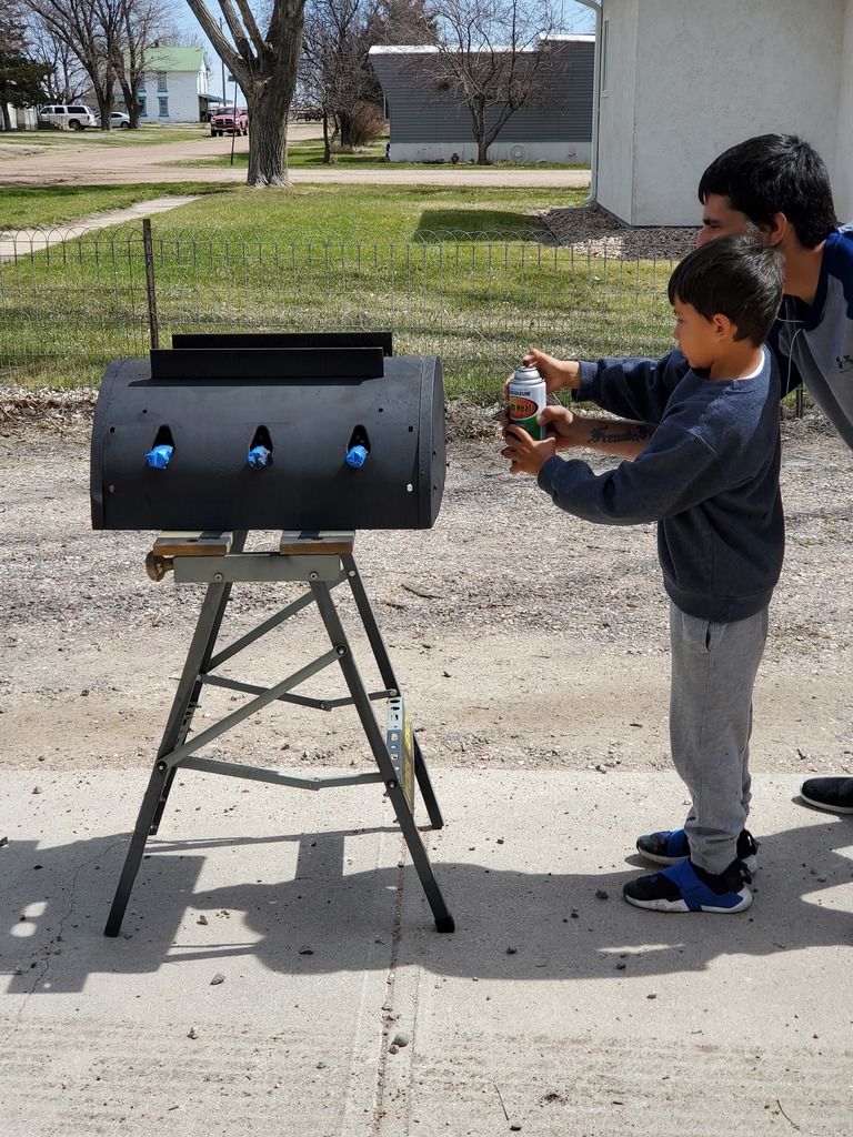 Xavier and dad working on grill