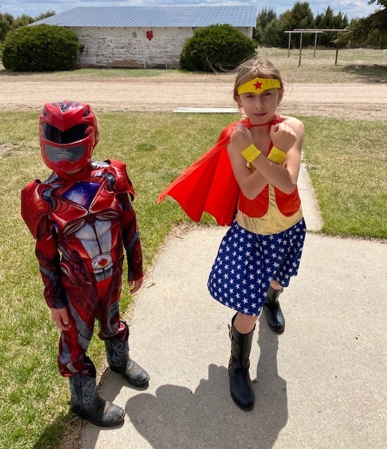 Kids dressed like iron man and wonder woman