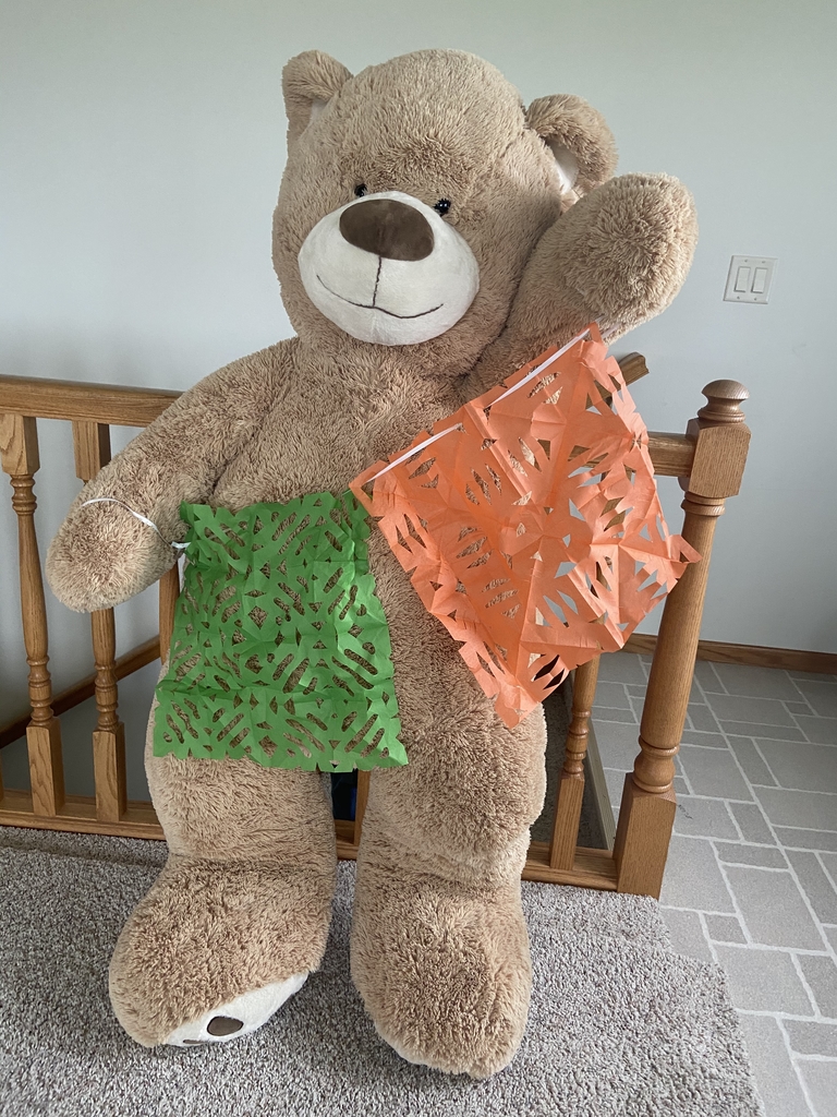 Teddy Bear standing with paper decoration.