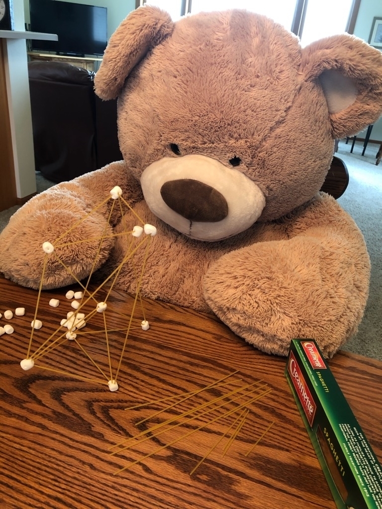 Teddy bear making a structure.