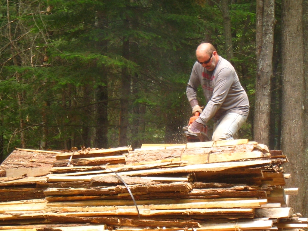 Cutting wood for the kiln.