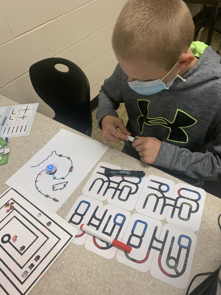 Student in STEM lab with robots.