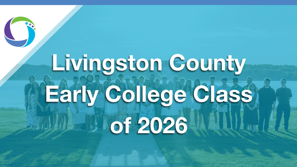 A group photograph of dozens of students standing in a long line on a green lawn with a body of water and trees in the background. A translucent teal or light blue overlay covers the image. Centered on top is large white text that reads "Livingston County Early College Class of 2026." In the upper left-hand corner, a white triangle showcases a circular logo with purple, green, and blue accents.